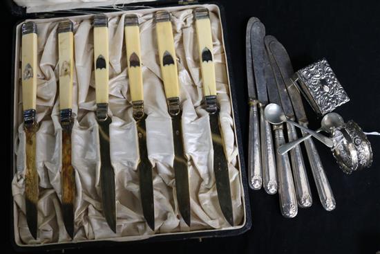 A cased set of French silver and ivory fruit knives, five tea knives, napkin ring and a matchbox holder.
